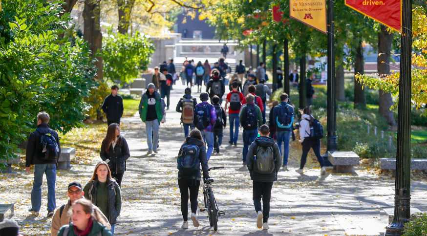 Students walk along Northrop Mall in the fall time